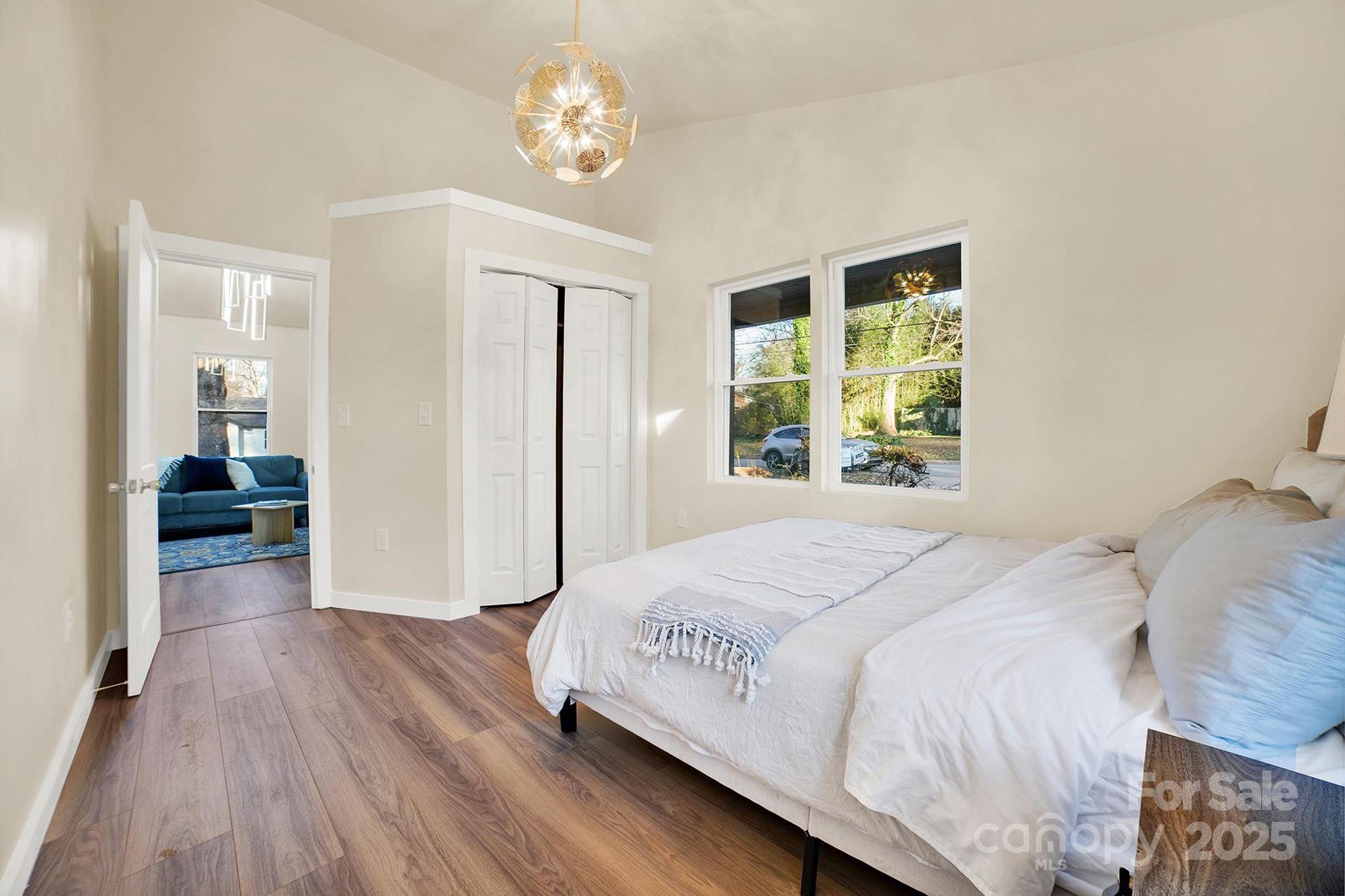 410 24th Street Southwest Hickory, NC 28602 - Photo 16 of 41 a bedroom with a large bed and a chandelier