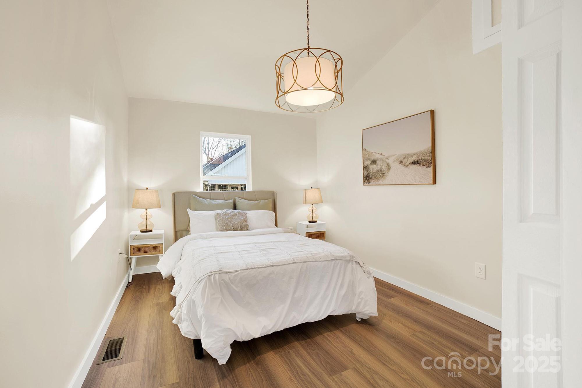 410 24th Street Southwest Hickory, NC 28602 - Photo 18 of 41 a bedroom with a bed and wooden floor