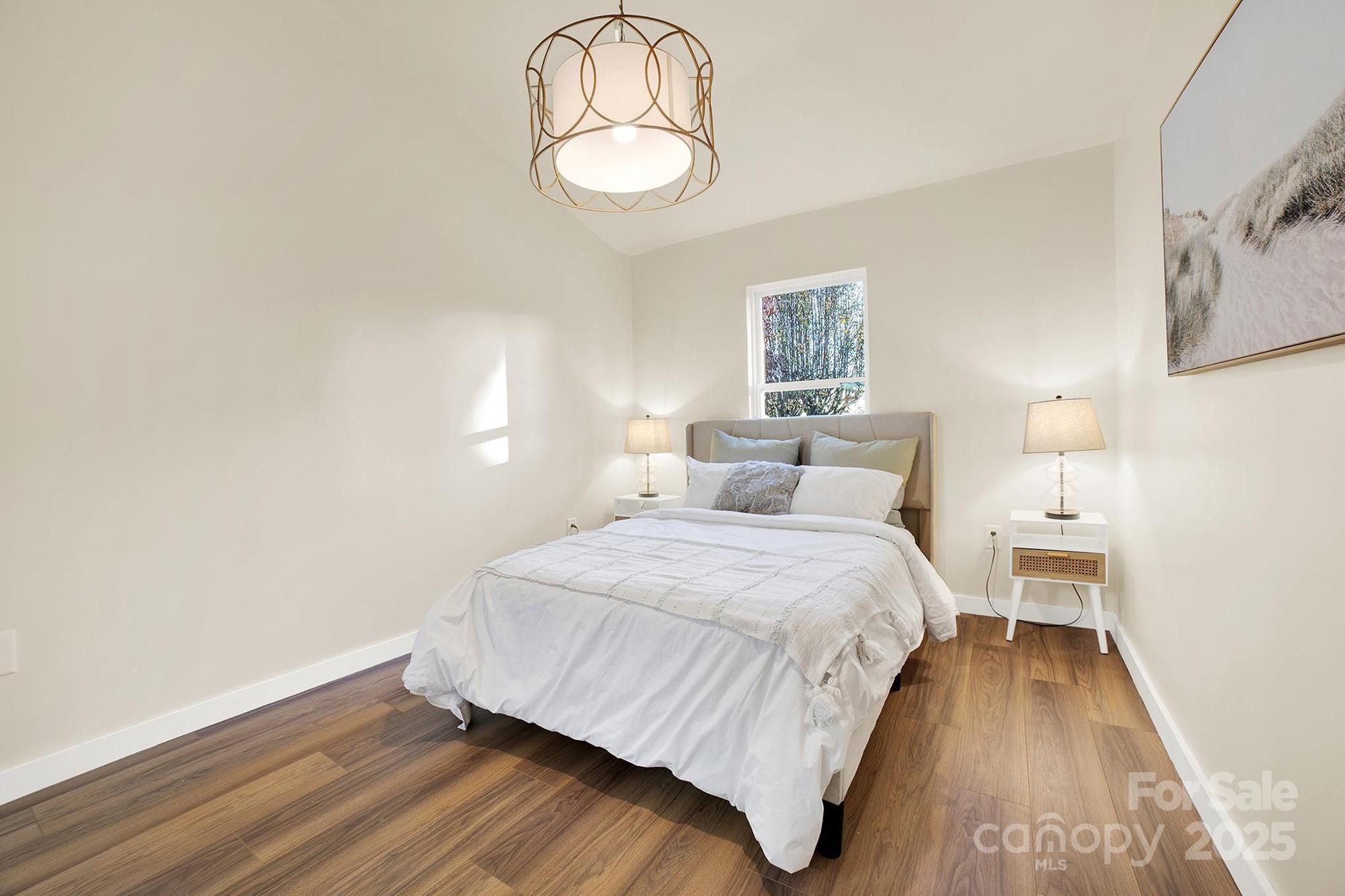 410 24th Street Southwest Hickory, NC 28602 - Photo 22 of 41 a bedroom with a bed and wooden floor