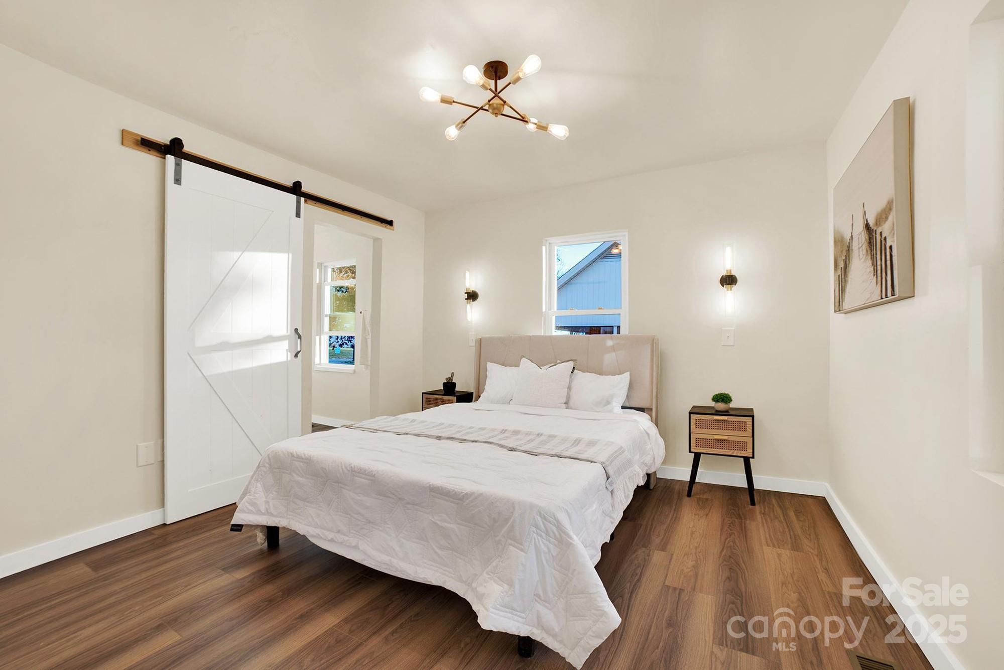 410 24th Street Southwest Hickory, NC 28602 - Photo 28 of 41 a bedroom with a bed and a chandelier