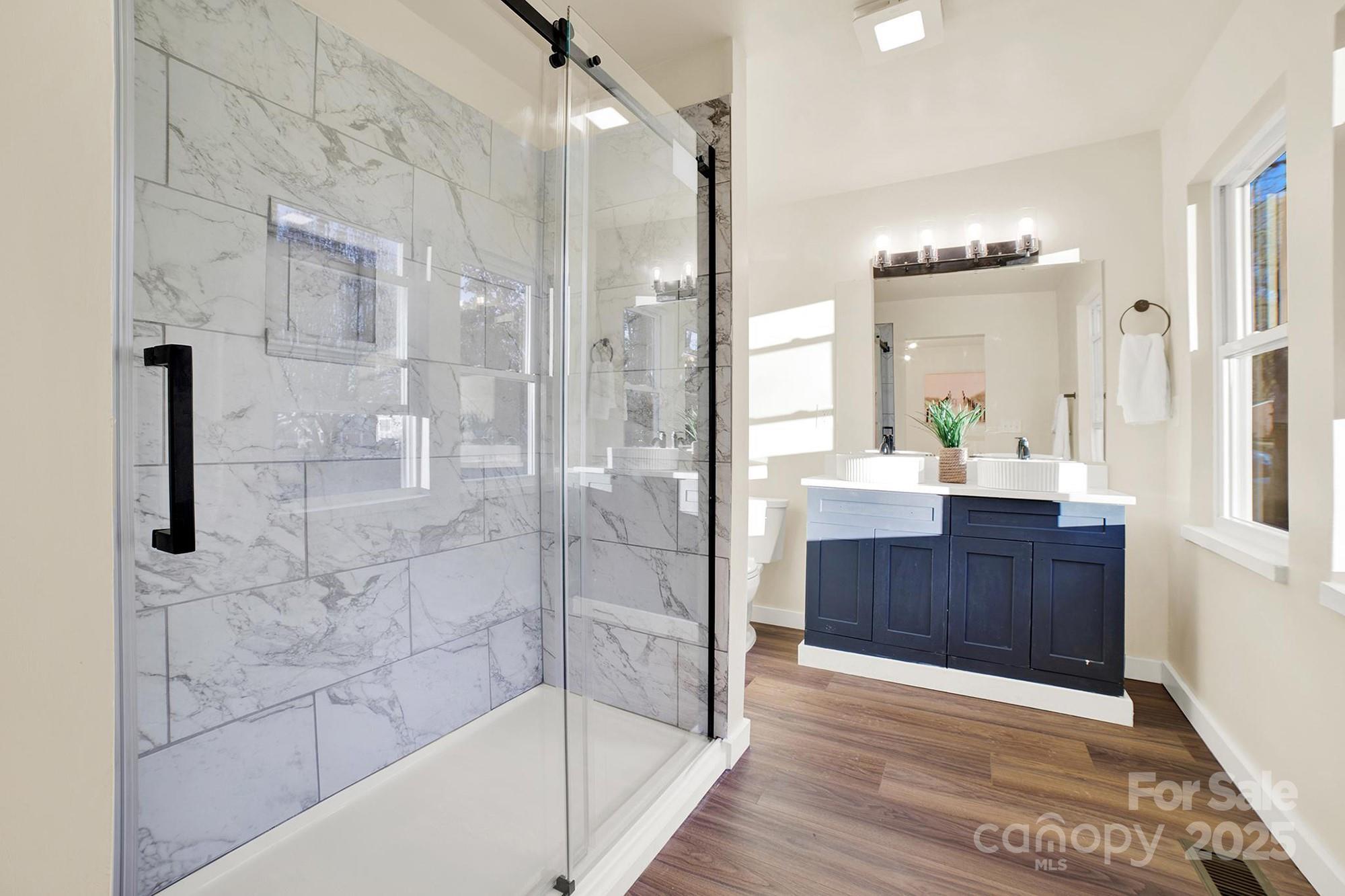 410 24th Street Southwest Hickory, NC 28602 - Photo 32 of 41 a bathroom with a glass shower door and a sink