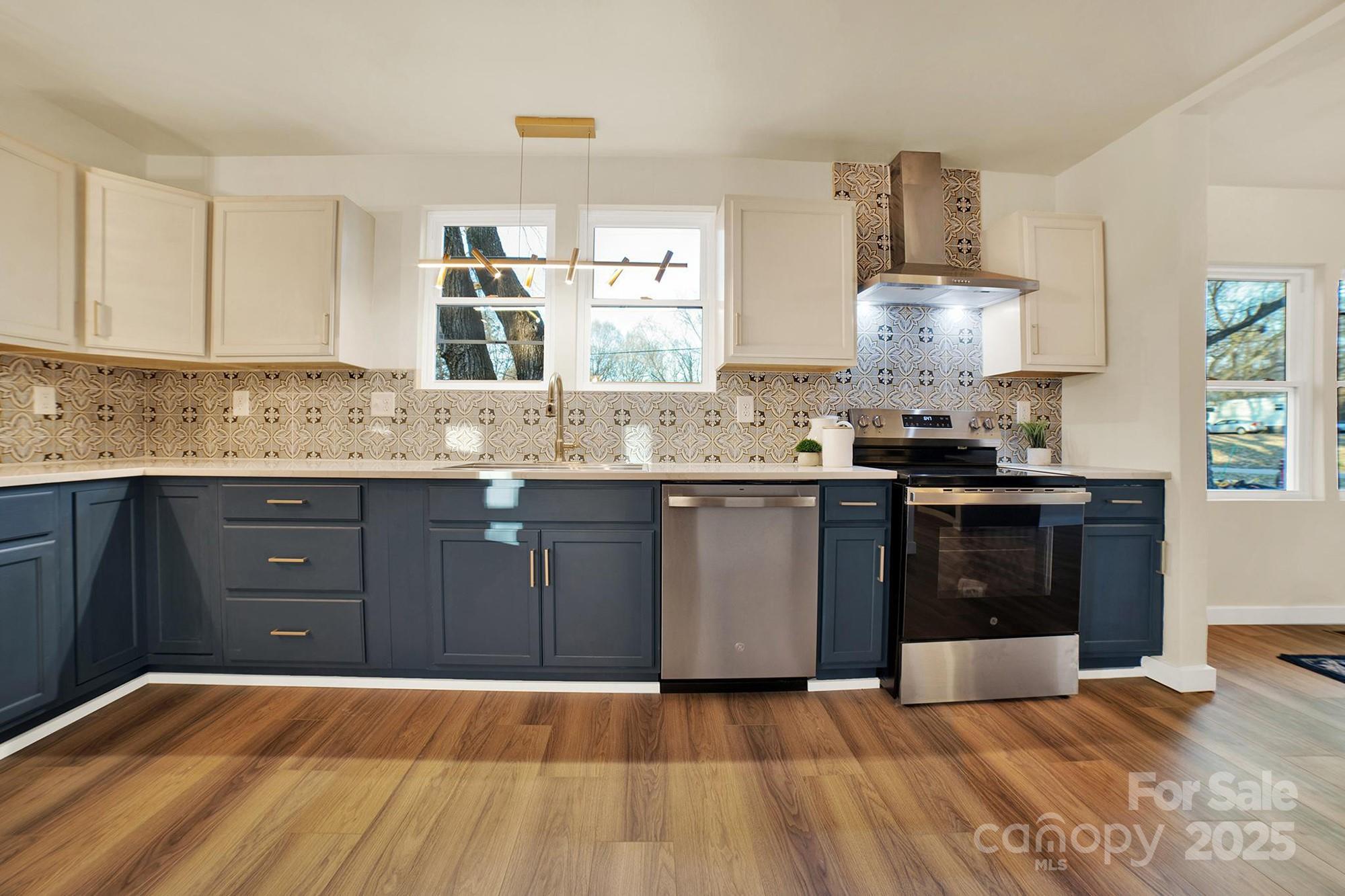 410 24th Street Southwest Hickory, NC 28602 - Photo 4 of 41 a kitchen with a sink a stove and cabinets