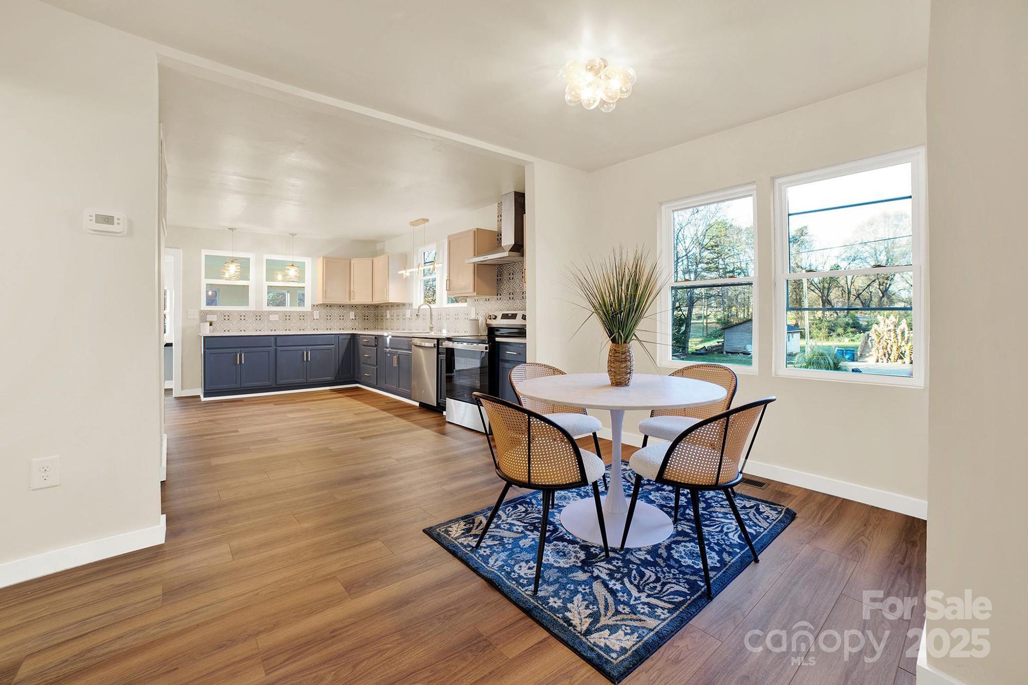 410 24th Street Southwest Hickory, NC 28602 - Photo 7 of 41 a view of a dining room with furniture window and wooden floor