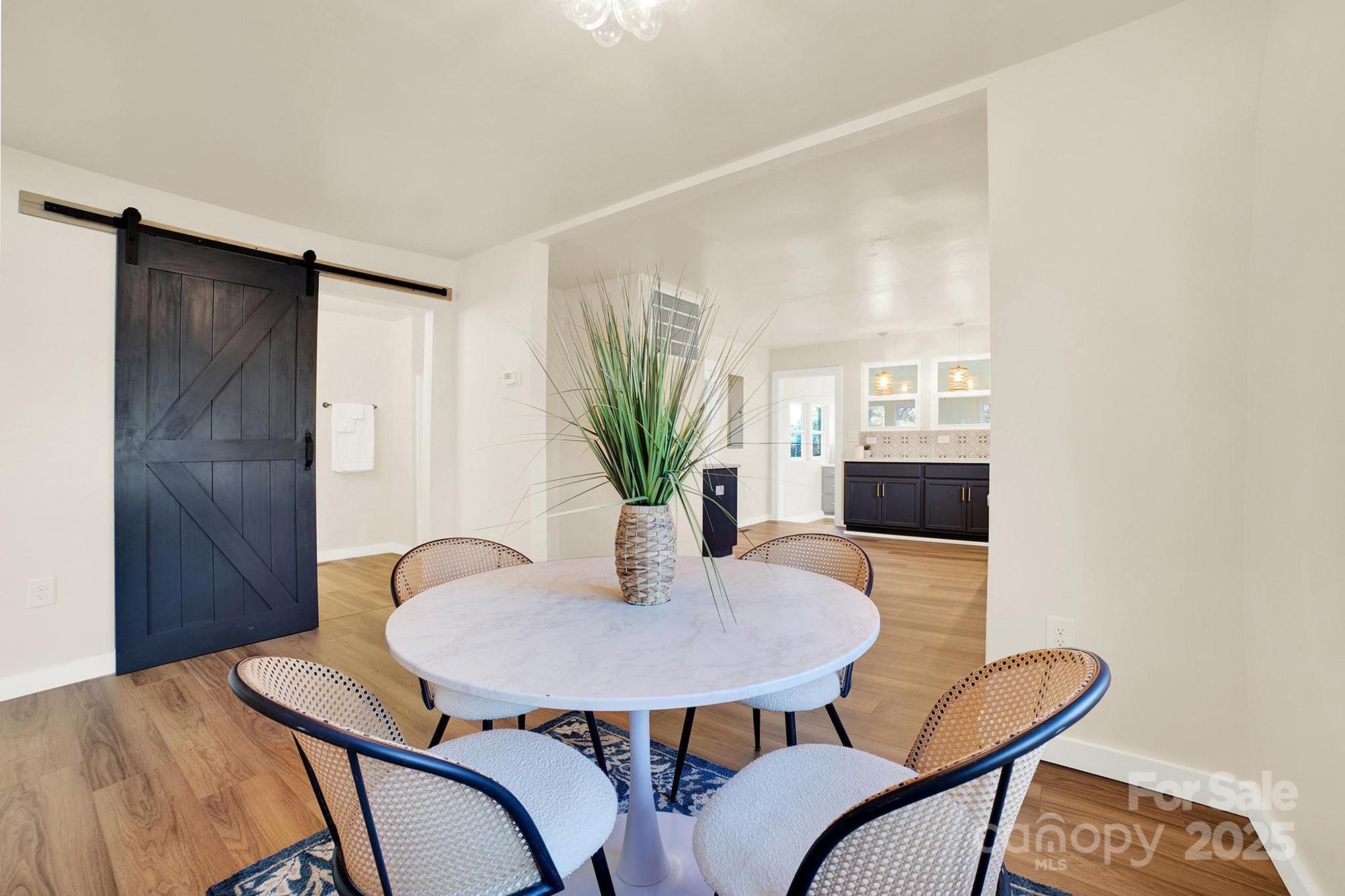 410 24th Street Southwest Hickory, NC 28602 - Photo 10 of 41 a view of a dining room with furniture and a potted plant
