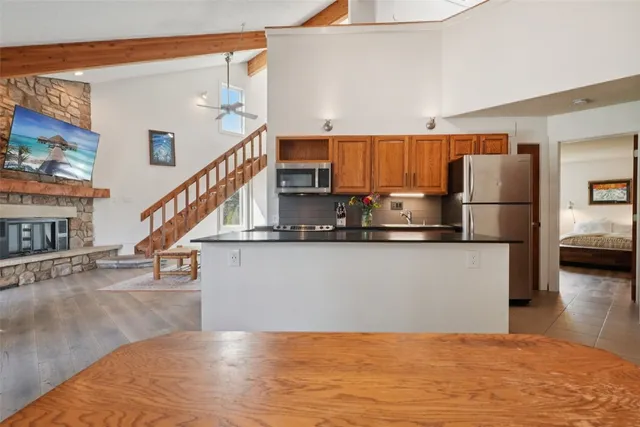 a living room with a bed furniture and a kitchen view