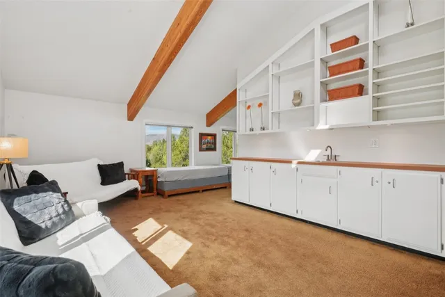 a living room with furniture and a painting on the wall