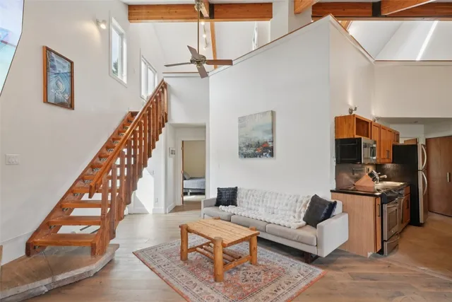 a living room with furniture and stairs