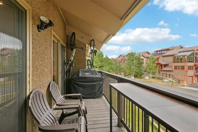 a balcony with wooden floor and outdoor space