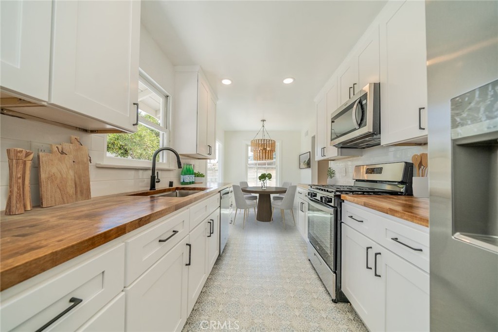 4165 Sequoia Street Riverside, CA 92503 - Photo 8 of 33 a kitchen with stainless steel appliances a sink stove and cabinets