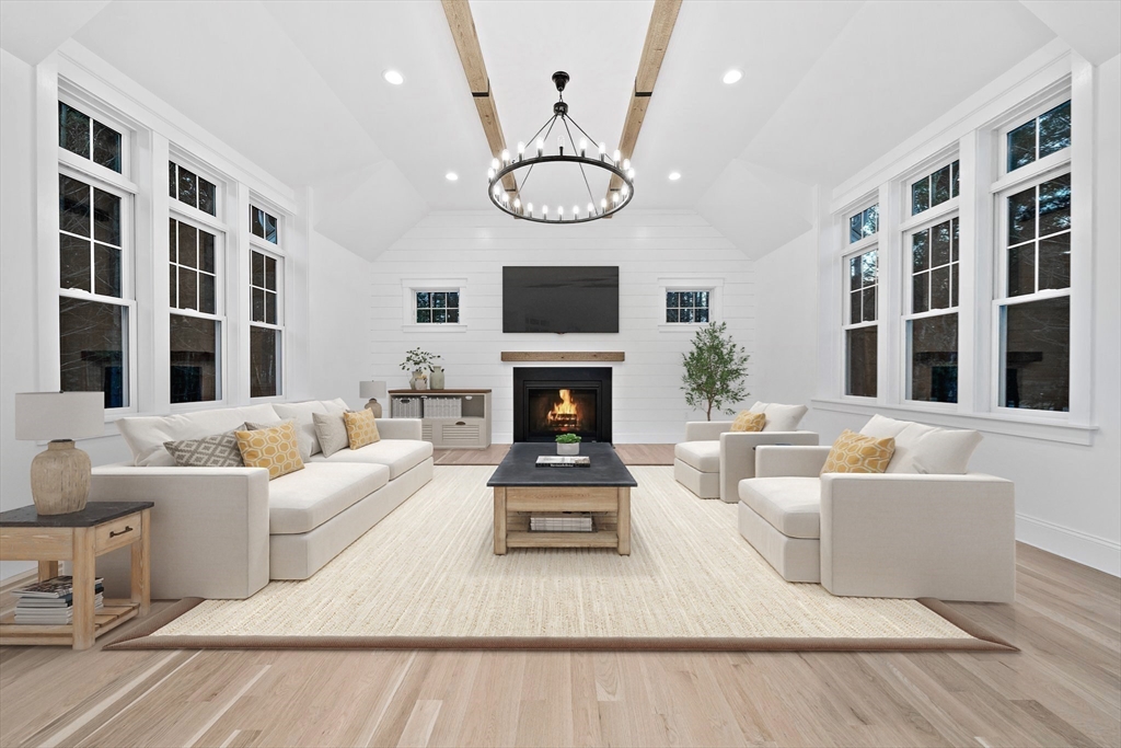 342 Country Club Way Kingston, MA 02364 - Photo 13 of 22 a living room with furniture a fireplace and a flat screen tv