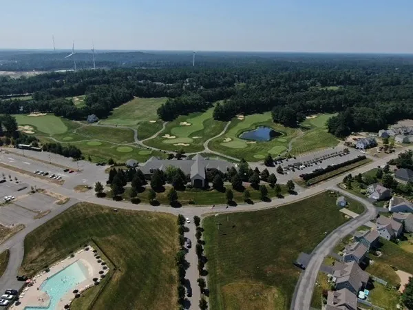 an aerial view of a house with yard swimming pool and outdoor seating