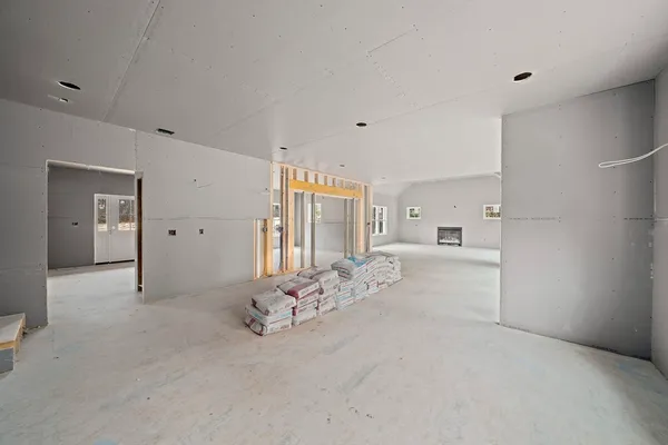 a large white bed with white cabinet