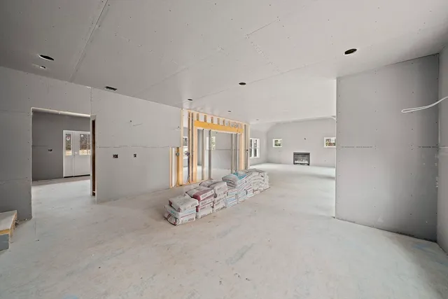 a large white bed with white cabinet