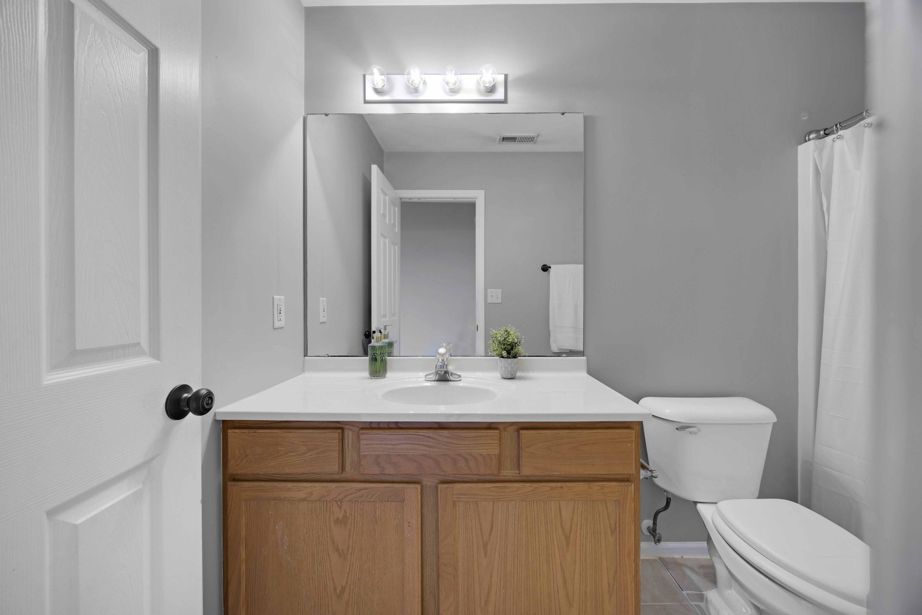 8461 Pierce Street Merrillville, IN 46410 - Photo 13 of 21 a bathroom with a sink vanity mirror and toilet