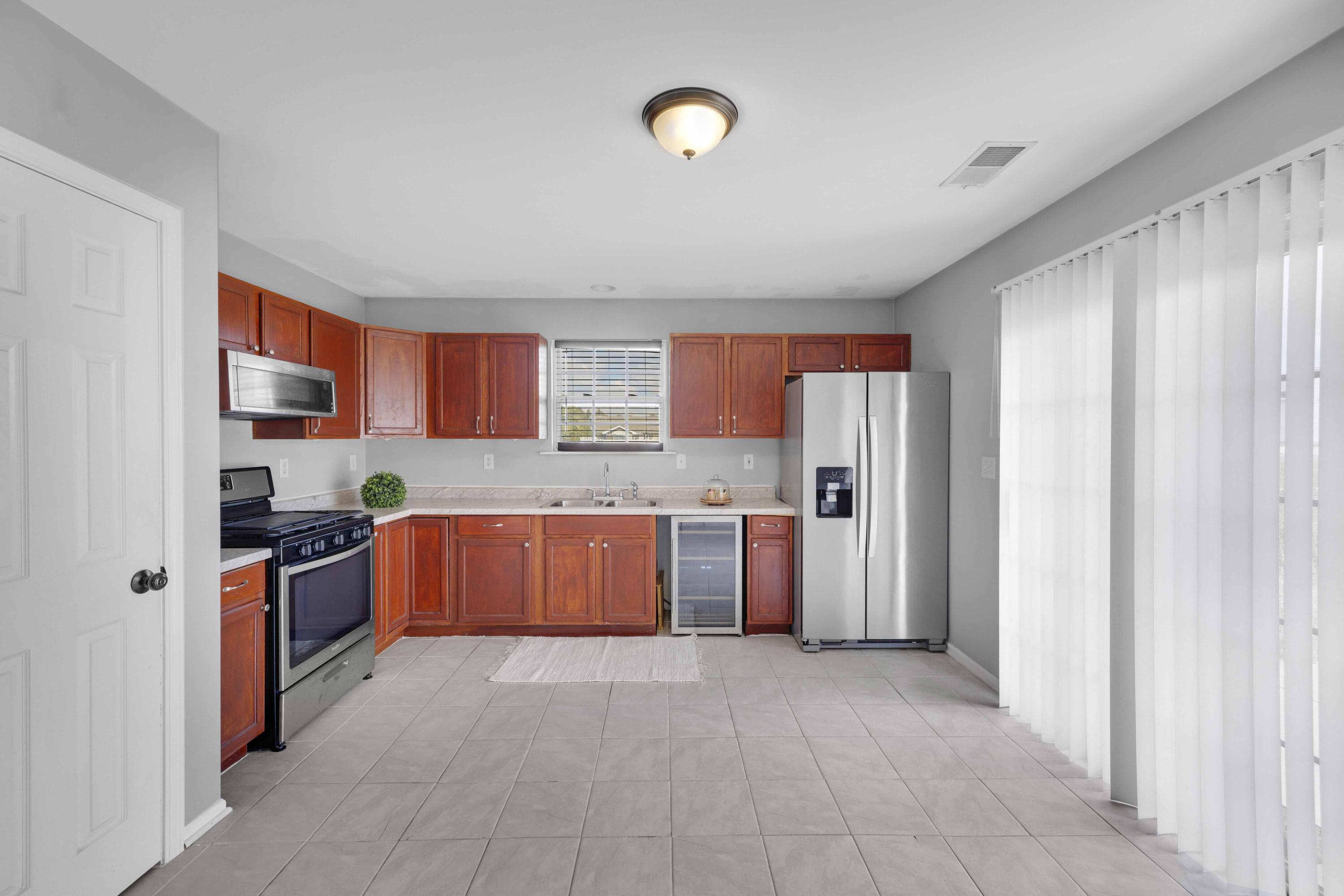 8461 Pierce Street Merrillville, IN 46410 - Photo 7 of 21 a large kitchen with stainless steel appliances granite countertop a refrigerator and a stove top oven