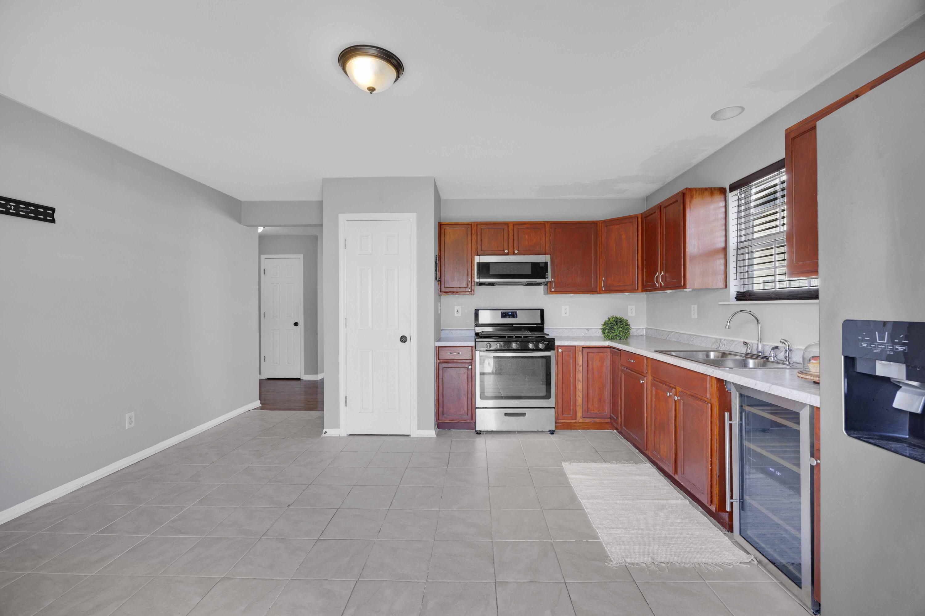 8461 Pierce Street Merrillville, IN 46410 - Photo 9 of 21 a kitchen with stainless steel appliances granite countertop a refrigerator stove top oven a sink and dishwasher