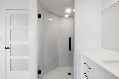 a bathroom with a shower and a sink