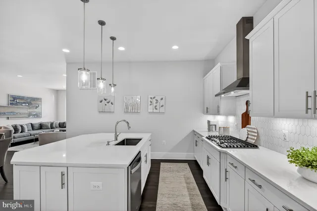 a kitchen with kitchen island a sink appliances and cabinets
