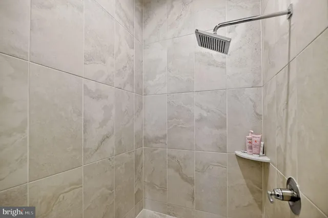 a view of a hallway with a livingroom and furniture