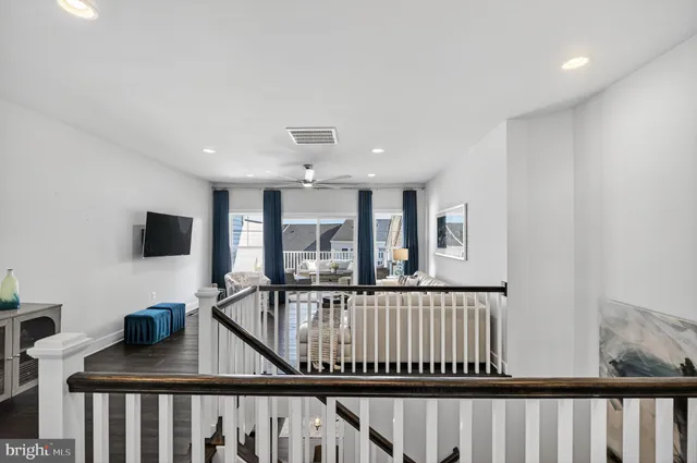 a bathroom with a granite countertop sink a toilet a mirror a vanity and shower