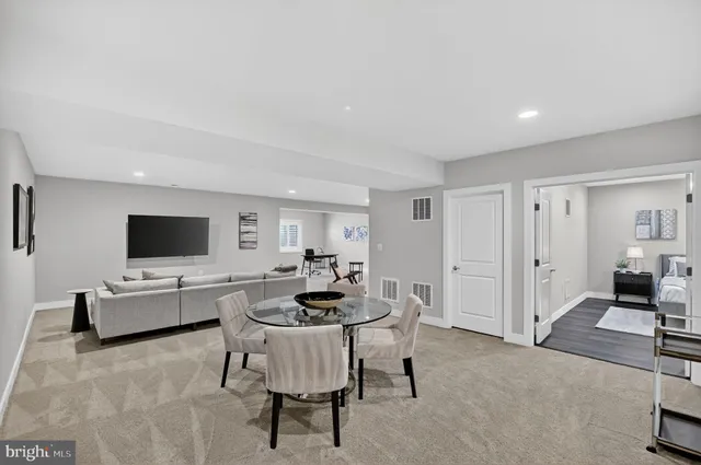 a living room with lots of furniture wooden floor and a chandelier