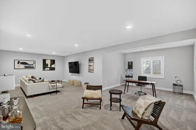 a living room with furniture floor to ceiling window and wooden floor