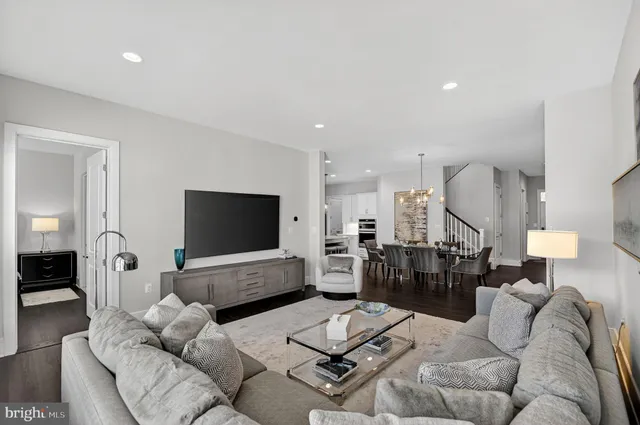 a kitchen with kitchen island a stove a refrigerator a sink dishwasher with a dining table and chairs