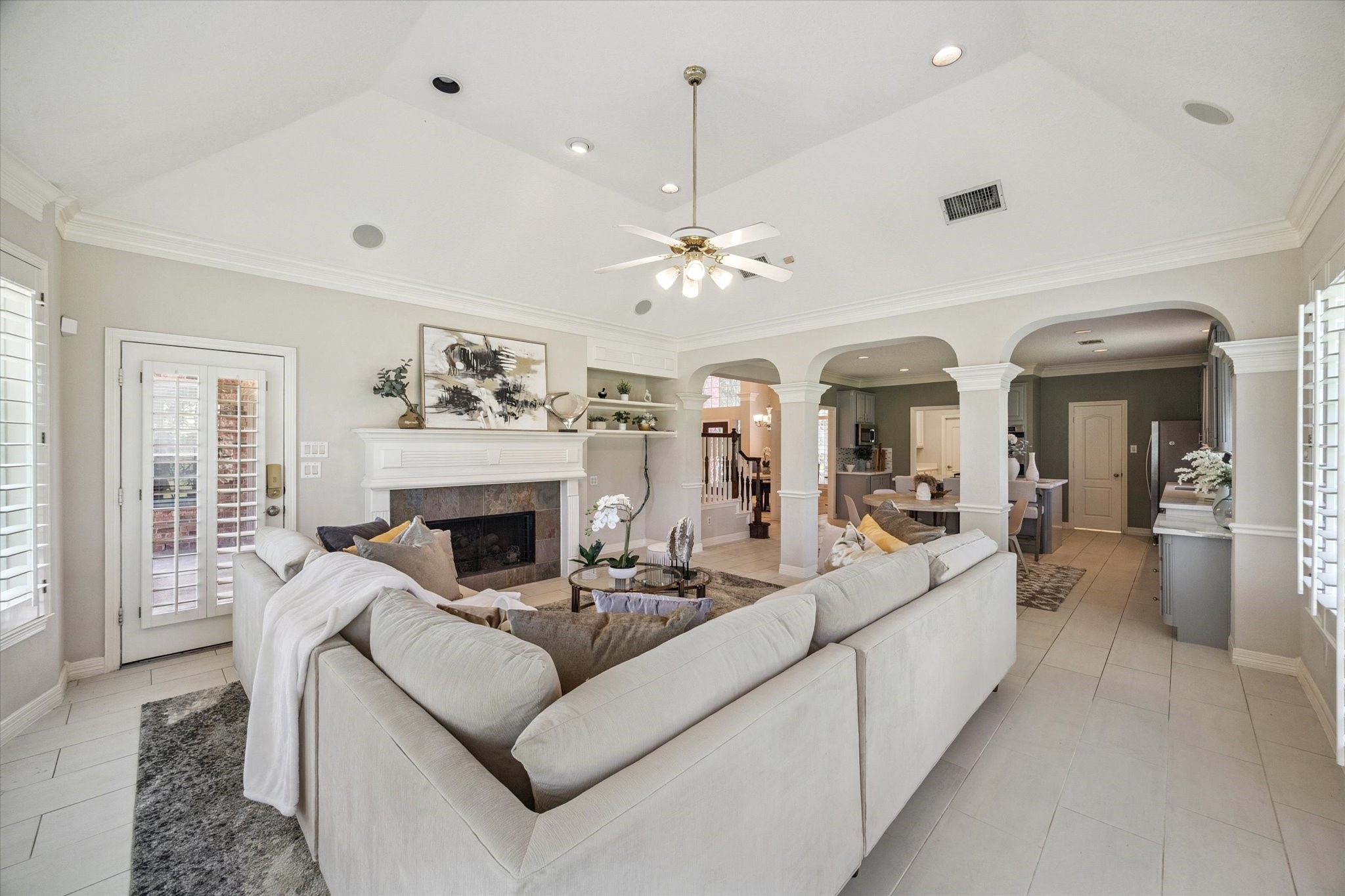 22522 Rippling Shore Court Katy, TX 77494 - Photo 15 of 41 a living room with furniture a fireplace and a chandelier