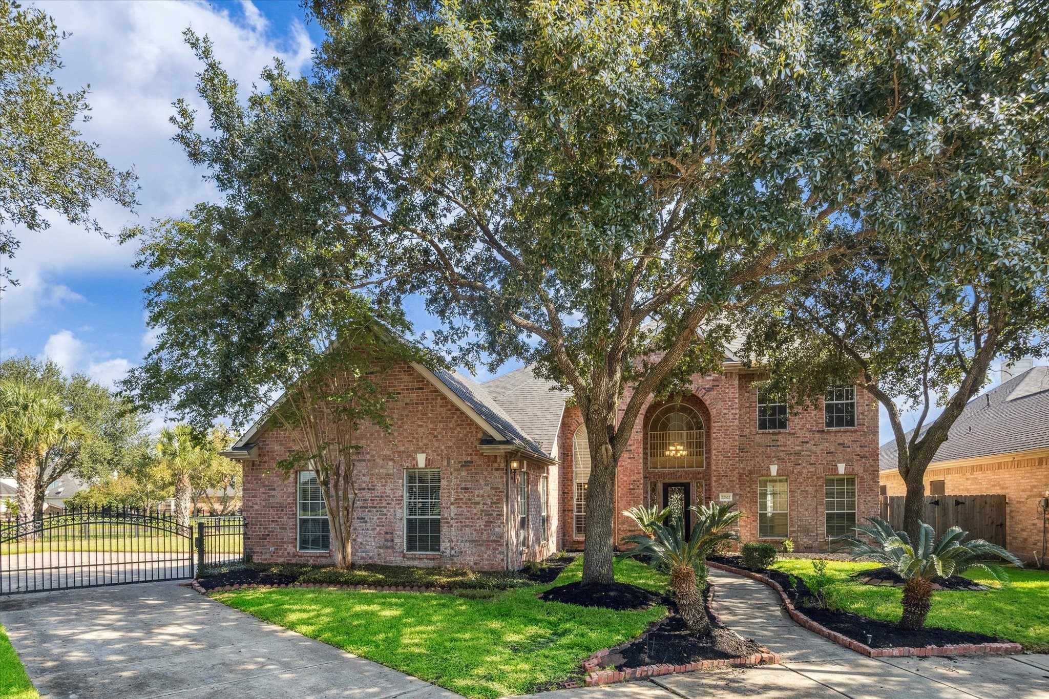 22522 Rippling Shore Court Katy, TX 77494 - Photo 3 of 41 a front view of a house with a garden