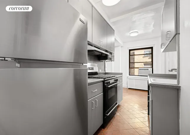 a kitchen with stainless steel appliances a refrigerator and a stove top oven