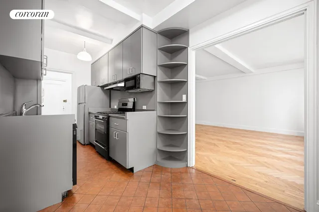 a kitchen with stainless steel appliances cabinets and a ceiling fan