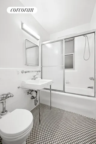 a bathroom with a sink toilet a mirror and shower
