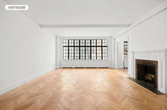 a view of an empty room with a fireplace