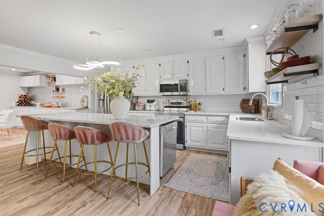 9820 Beaver Bridge Road Chesterfield, VA 23838 - Photo 18 of 54 Bright kitchen featuring a central island with cou
