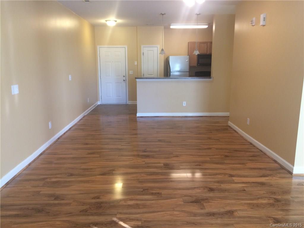 10125 Westmoreland Road, Unit 1B Cornelius, NC 28031 - Photo 4 of 15 a view of an empty room with wooden floor