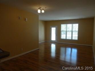 10125 Westmoreland Road, Unit 1B Cornelius, NC 28031 - Photo 6 of 15 a view of empty room with wooden floor and fan