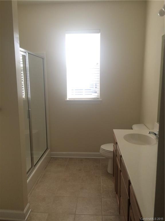 10125 Westmoreland Road, Unit 1B Cornelius, NC 28031 - Photo 7 of 15 a bathroom with a bathtub and a shower