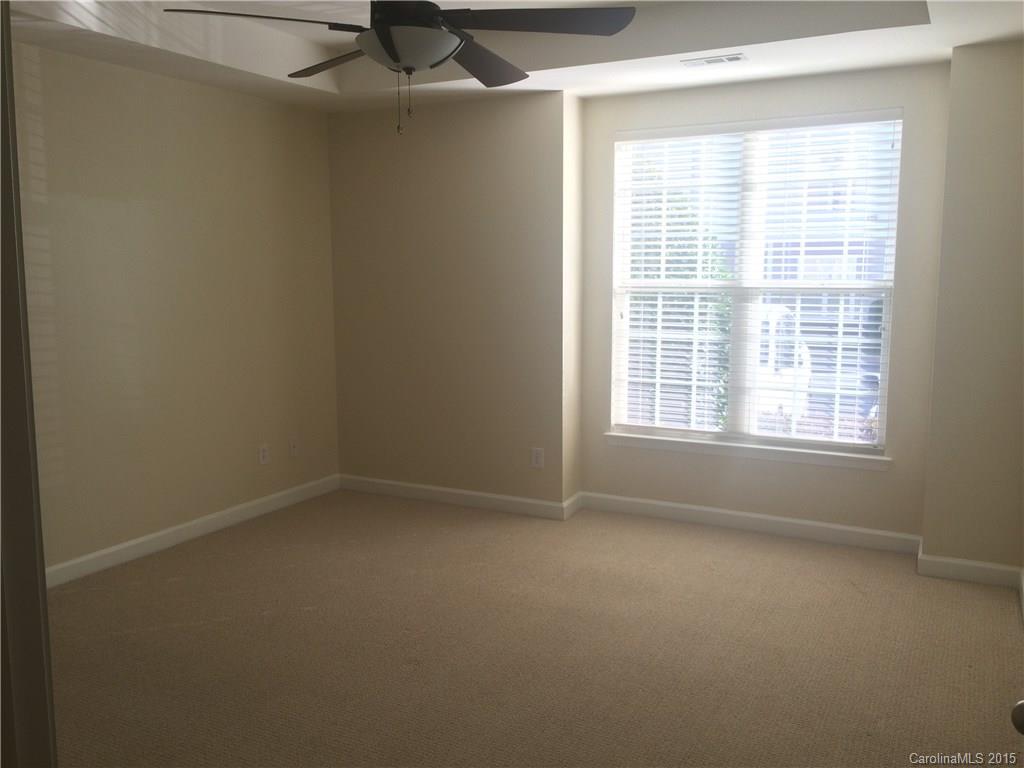 10125 Westmoreland Road, Unit 1B Cornelius, NC 28031 - Photo 9 of 15 an empty room with a empty space and windows
