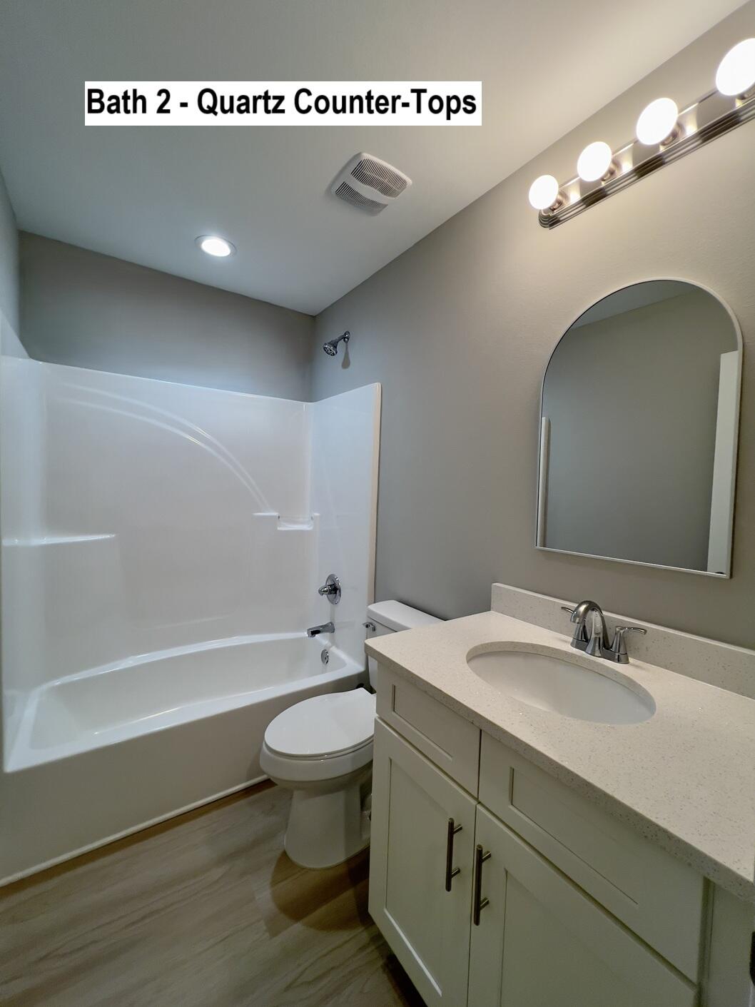 455 Scooter Cove Crestview, FL 32539 - Photo 12 of 15 a bathroom with a sink a toilet a mirror and bathtub