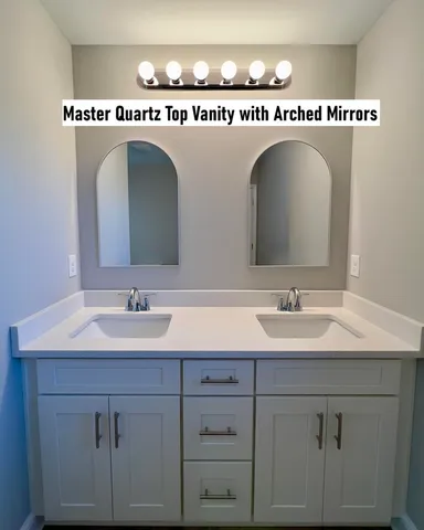 a bathroom with a sink a mirror and a vanity