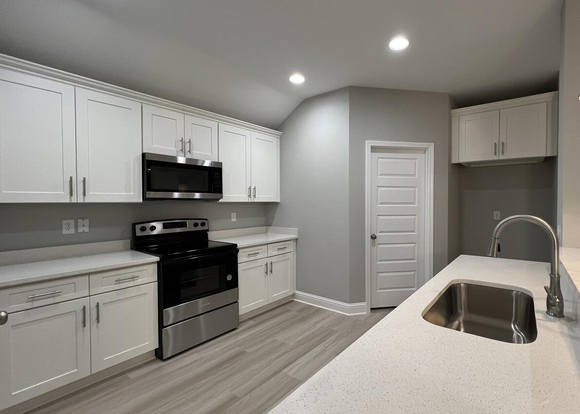 455 Scooter Cove Crestview, FL 32539 - Photo 5 of 15 a kitchen with kitchen island granite countertop a sink stainless steel appliances and cabinets