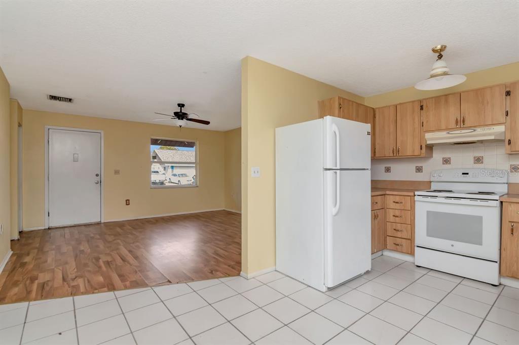7544 Humboldt Avenue New Port Richey, FL 34655 - Photo 13 of 24 a kitchen with white cabinets and white appliances