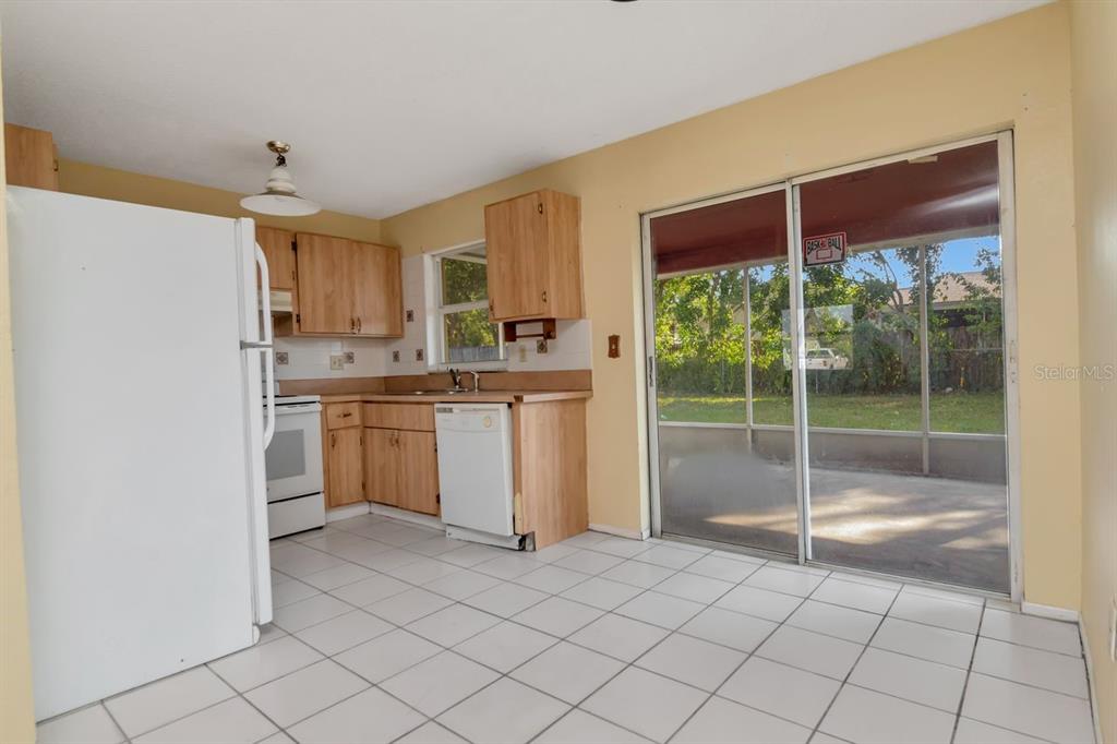 7544 Humboldt Avenue New Port Richey, FL 34655 - Photo 14 of 24 a kitchen with white cabinets and white appliances