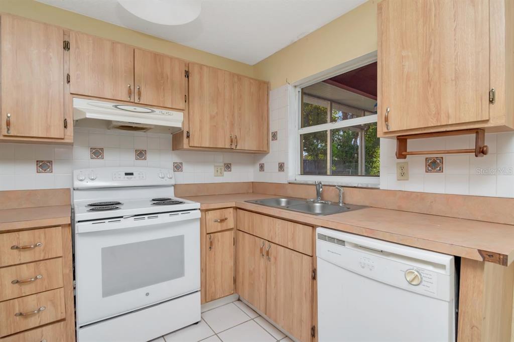7544 Humboldt Avenue New Port Richey, FL 34655 - Photo 10 of 24 a kitchen with appliances cabinets and a sink
