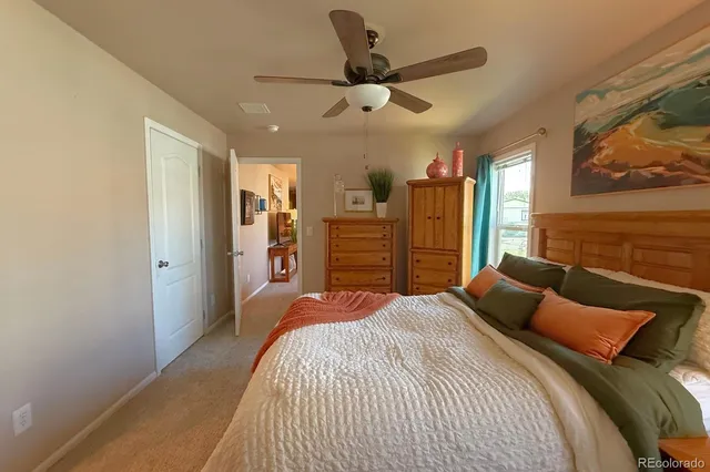 a bedroom with a bed and a large mirror