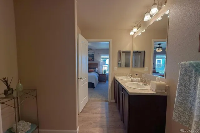 a en suite bathroom with a double vanity sink a mirror and a shower