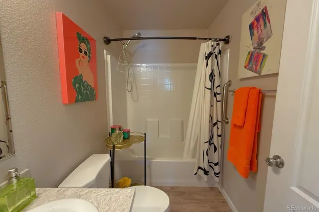 a bathroom with a shower and toilet