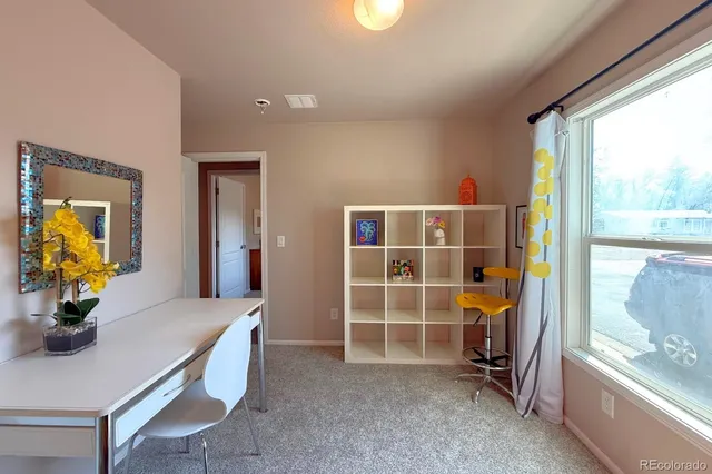 a view of a livingroom with furniture and a window