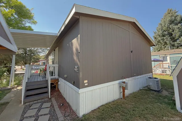 a view of a house with backyard and wooden fence