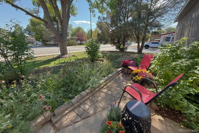 a view of patio with a table and chairs and potted plants